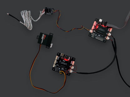 Beyond Robotix Micro CAN Node development set with two circuit boards, a Hitec servo, and wiring on a white background